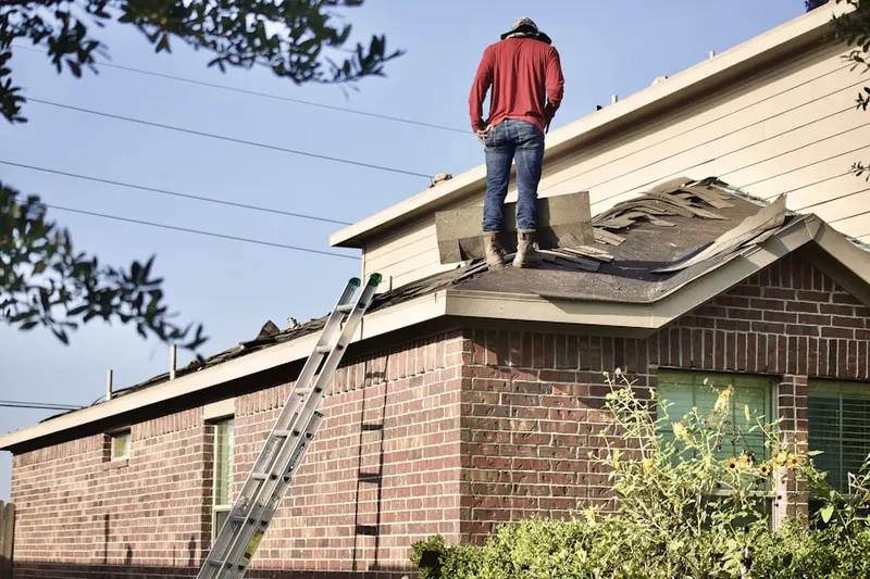 Professional roofer working on a residential roof in Derstine Estates